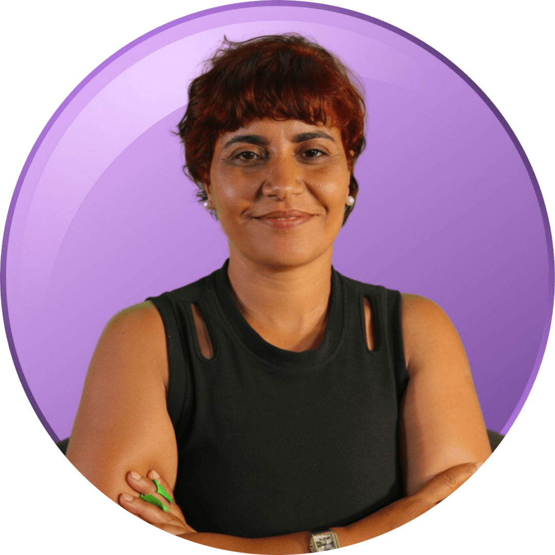 Smiling woman with short hair against a purple background.