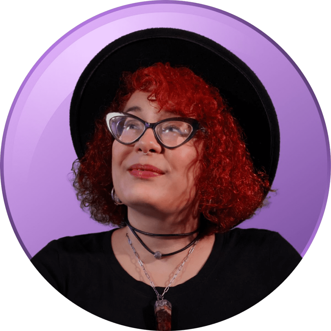Woman with red curly hair and glasses wearing a black beret and choker.