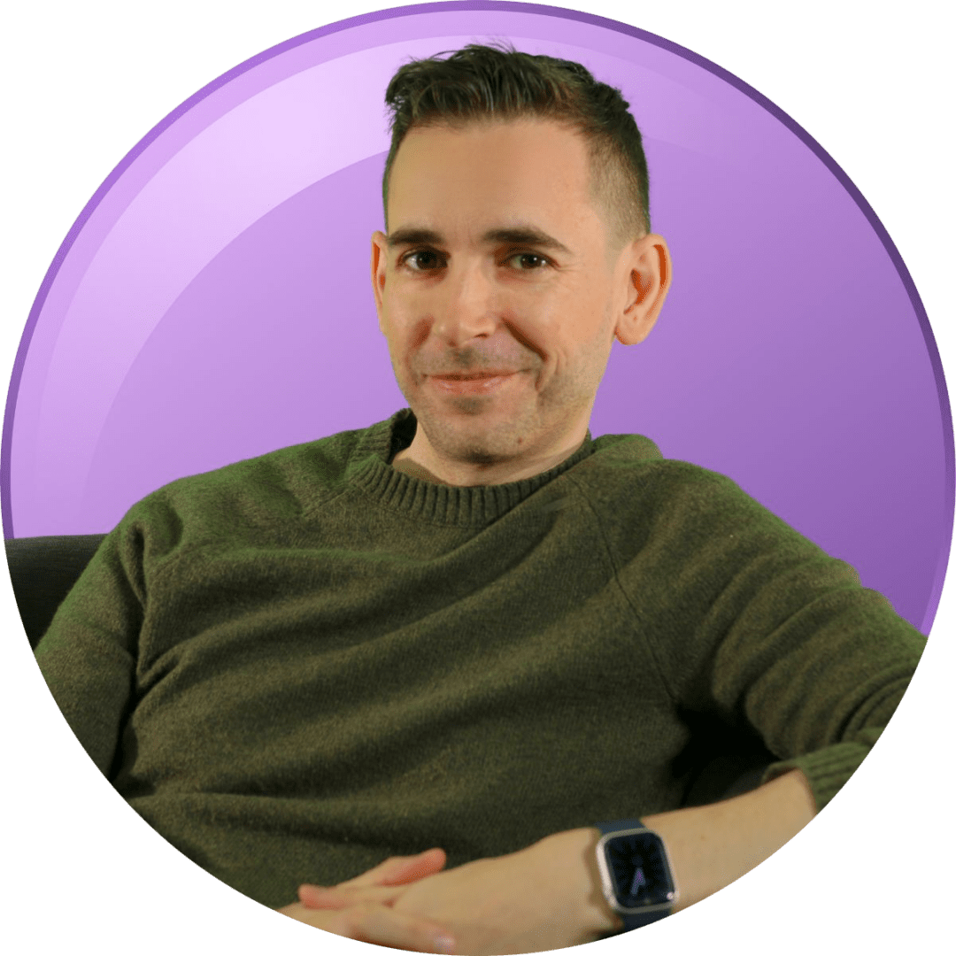 Man in green sweater posing against a purple background.